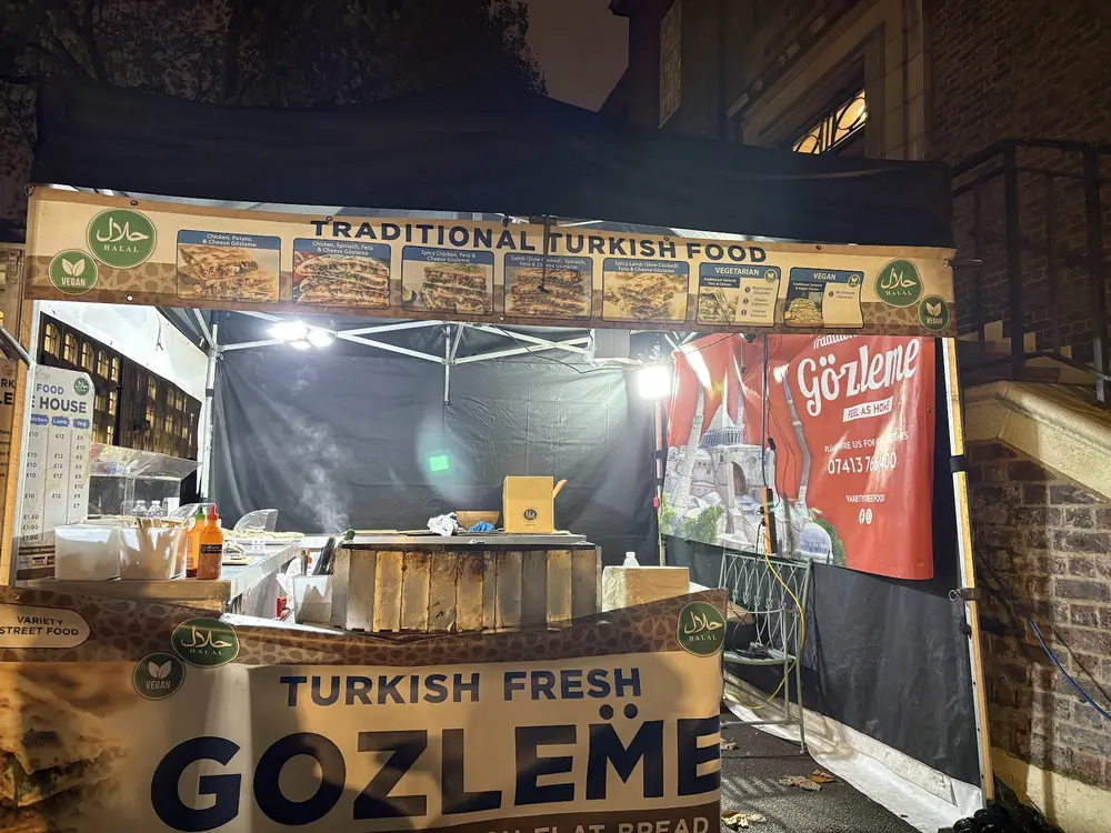 The Turkish Gozlame stall lit up at night, hot plate going under the Traditional Turkish Food banner